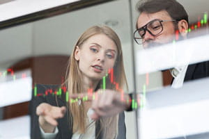 Businesswoman and businessman talking profit on futuristic display