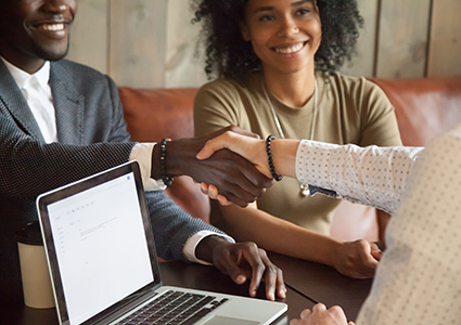 Happy african american couple making deal handshaking caucasian broker, closeup